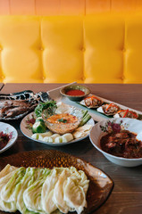 Various kinds of Thai food on dinner table with colourful background