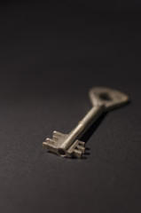 Old vintage key on black background. Retro keys.