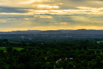 Landscape of cloudy, mountain and forest with sunset in the evening from top view.