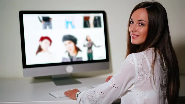 Young businesswoman using modern internet technologies at home. Woman ordering fashionable clothes of famous brands