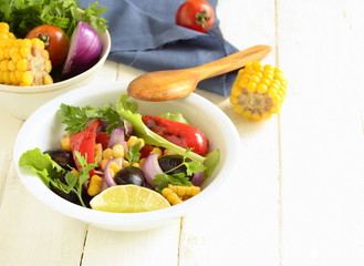Fried salad with black beans, corn, sweet pepper and red onion, copy space
