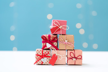 Small Christmas gift boxes on a shiny light blue background