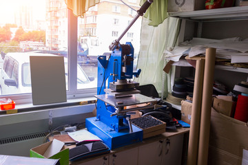 Press machine in the workshop for doing the embossed logo and letters on the leather product that heats the cliche and squeezes the desired image on the material