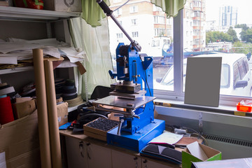 Press machine in the workshop for doing the embossed logo and letters on the leather product that heats the cliche and squeezes the desired image on the material