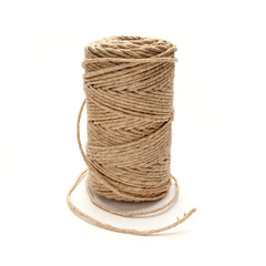 Spool of hemp string on a white background