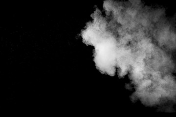 Explosion of white dust on black background.