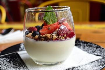 Panna cotta topped with strawberries and blueberries.