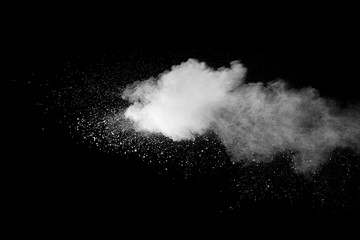 Explosion of white dust on black background.
