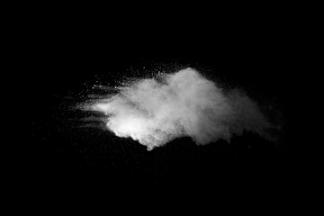 Explosion of white dust on black background.