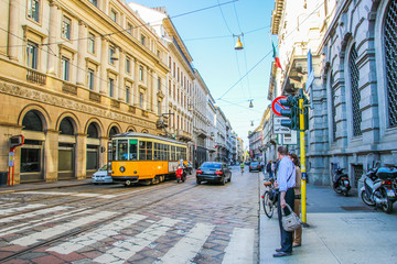 Naklejka premium Tram and traffic on the old paved Streets of Milan