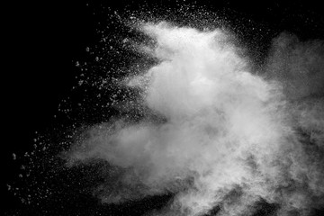 Explosion of white dust on black background.