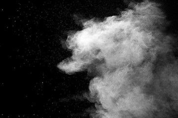 Explosion of white dust on black background.