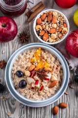 oatmeal with fruit and nuts, healthy breakfast, top view
