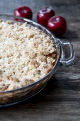 Closeup apple crisp crumble dessert with apples in background