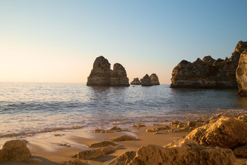 Sandy ocean beach Praia Dona Ana with famous beautiful coastal cliffs in Lagos, Algarve, Portugal