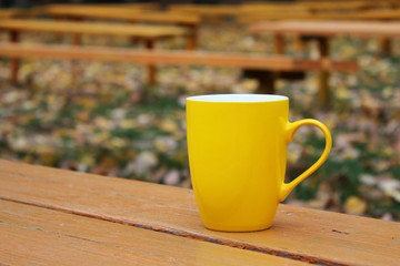 Yellow Cup on an orange bench.