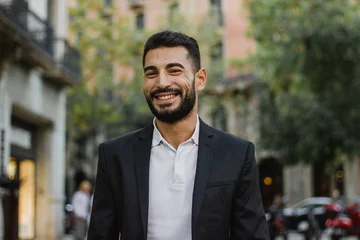 Foto op Plexiglas Handsome arabic guy smiling. Successful man walking on the street © Clara