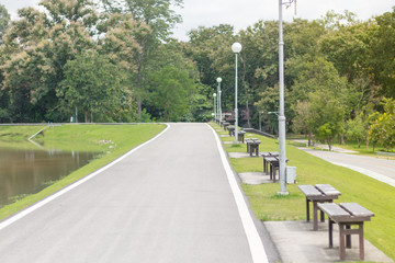 A wooden bench on the street. For people sitting in the park.