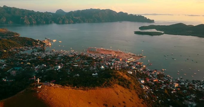 Aerial - drone flying over the hill with a cross. Mt Tapyas in Coron, Palawan, Philippines.