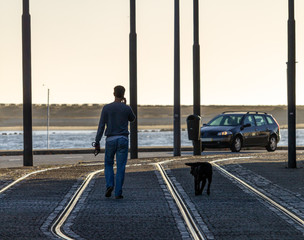 Man and Dog on Cobbled Street