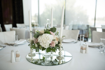 wedding banquet table served and decorated with fresh flowers and white candles. Wedding decoration concept
