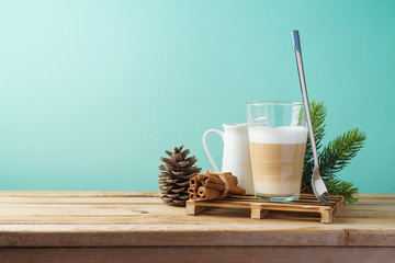 Hot Latte macchiato coffee cop  on wooden table. Christmas menu concept