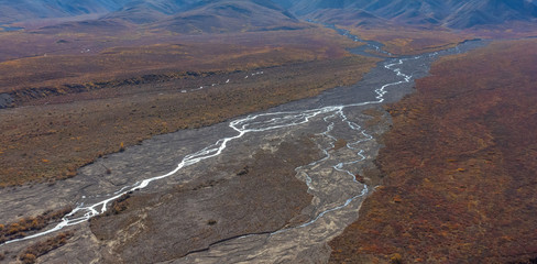Fototapeta na wymiar braided river coursing through valley in Denali National Park and Preserve in fall