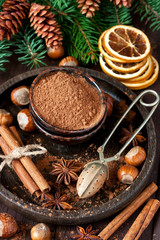 Cocoa powder and spices on wooden background