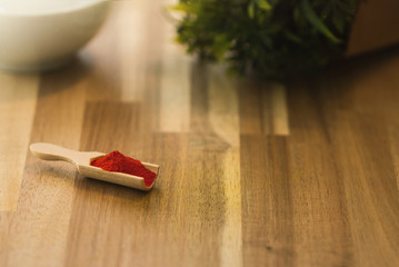 Saffron spice powder on a wooden spoon