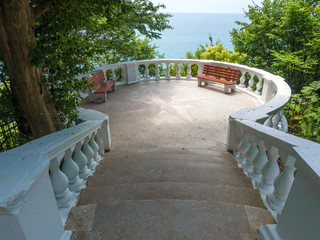 Observation deck with stairs and sea views located in the forest