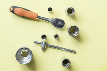 flat lay set of wrenches isolated on color surface f