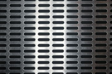 stainless steel grating with oblong holes, close-up