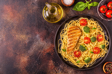 Plate of spaghetti tomato broccoli chicken