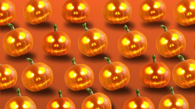 Group of Halloween Jack o Lanterns on orange background. 4k video.