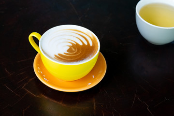 Latte hot coffee on black table