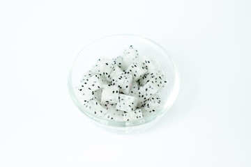 Dragon Fruit diced in a glass bowl on white background