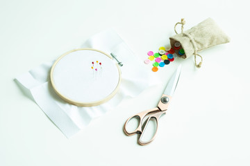 Sewing equipments : pin on embroidery hoop, scissors, buttons