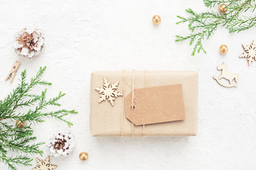Kraft paper Christmas gift, empty tag on white background. New Year's decorations. Winter holiday...