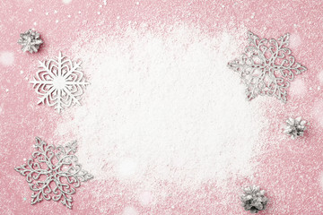 Cherry pink Christmas frame of snow and silver snowflakes. Winter holidays greeting card with copy space. New Year.