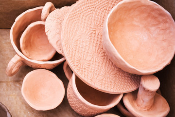 Handmade earthenware dries in the sun before firing. Handmade ceramics. Pottery