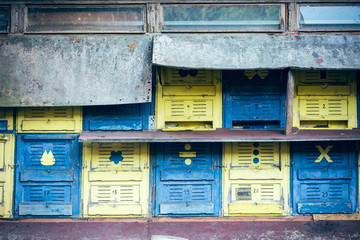 Colorful old postal boxes on condominium