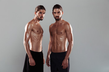 Fototapeta na wymiar Portrait of a two muscular shirtless twin brothers
