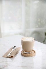 cappuccino or Latte art coffee made from milk on the wood table in coffee shop