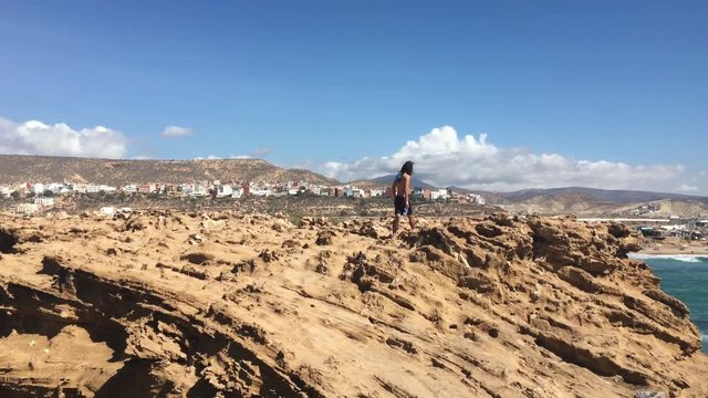 Man Walking on Rocks in Tamraght, Morocco