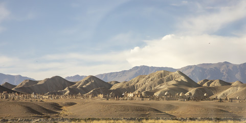 Plakat Islamic graveyard on hillside in rural Kyrgyzstan