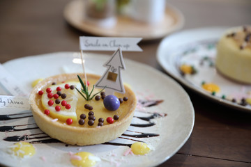 Lemon tart pie topping with chocolate ball sweet dessert on wood background