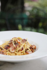 Spaghetti carbonara , Spaghetti white sauce with cheese bacon in outdoor restaurant italian food