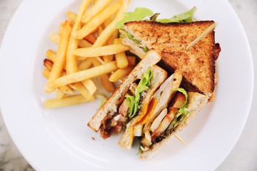 Club sandwich , Sandwich with egg bacon chicken tomato with fried outdoor restaurant background
