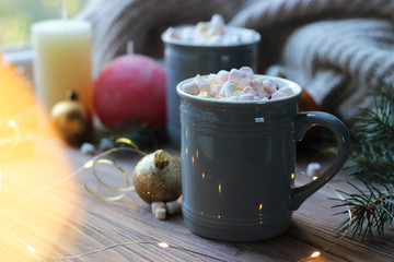  Hot cocoa, christmas accessories and garland on a wooden table. Warming drinks