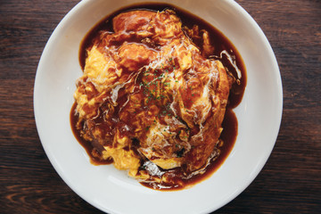 Curry rice with omelet Japanese style on wood background film vintage style
